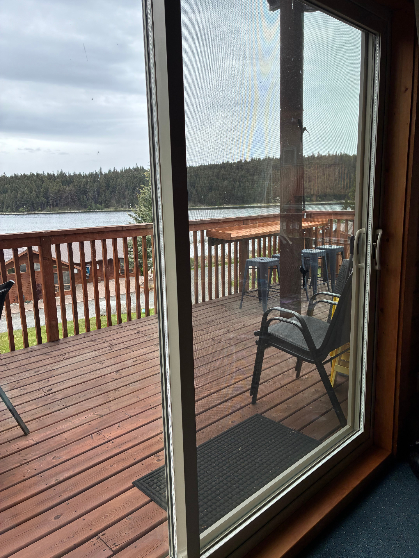 Interior view through the updated sliding door toward the deck and lake