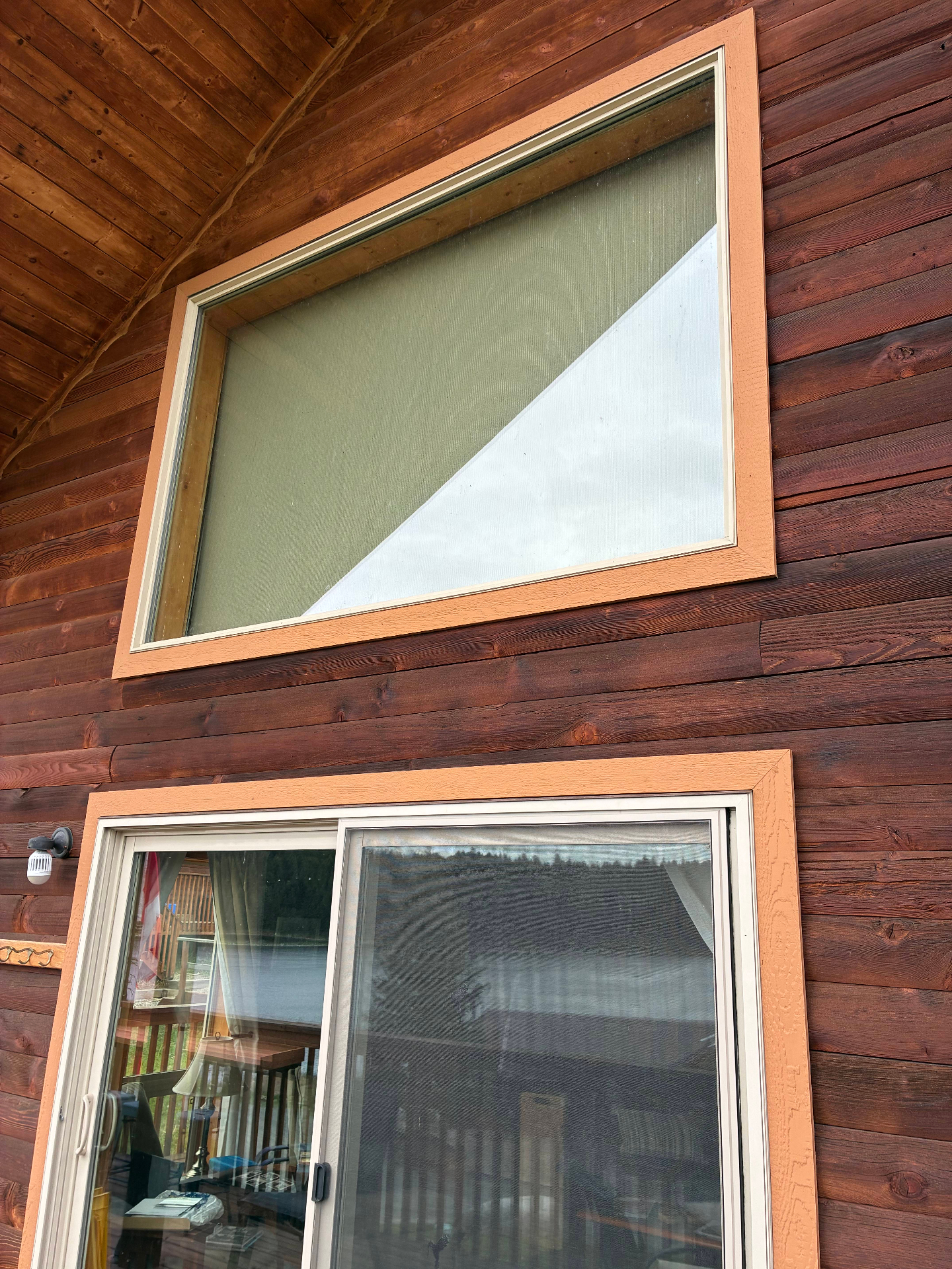 Upper gable window with refreshed trim on the Roche Lake cabin exterior