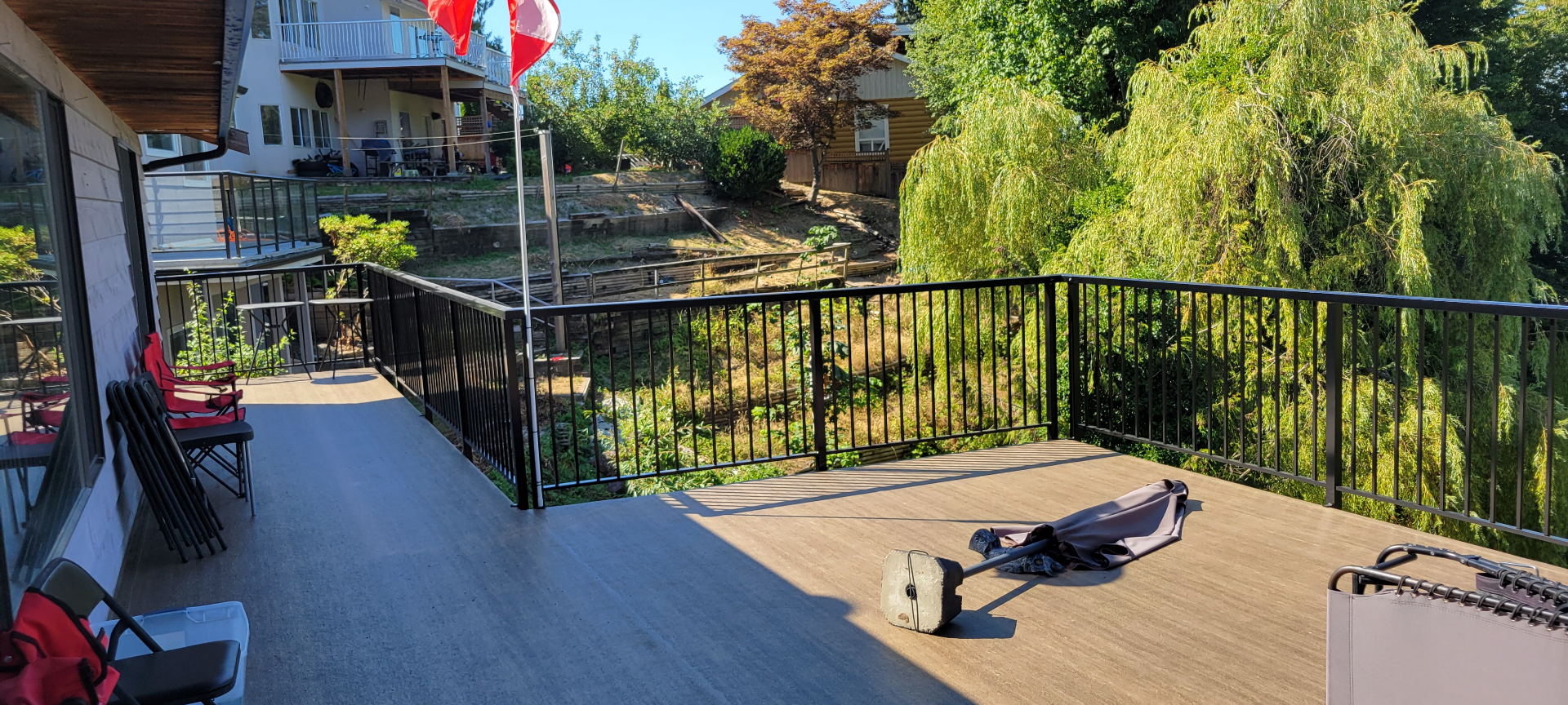 Wide rebuilt deck with vinyl surface and black aluminum railing