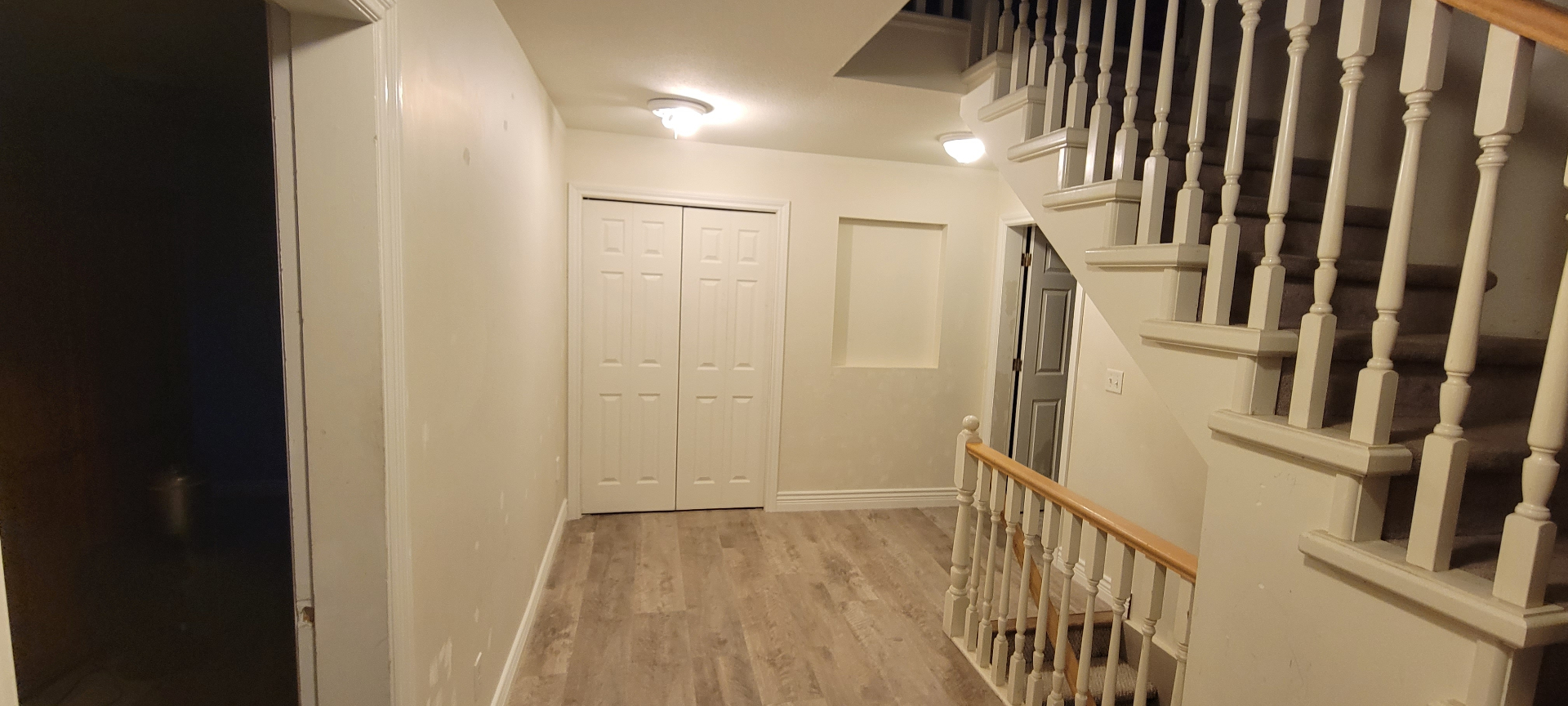 Residential entry and stair landing with new laminate flooring