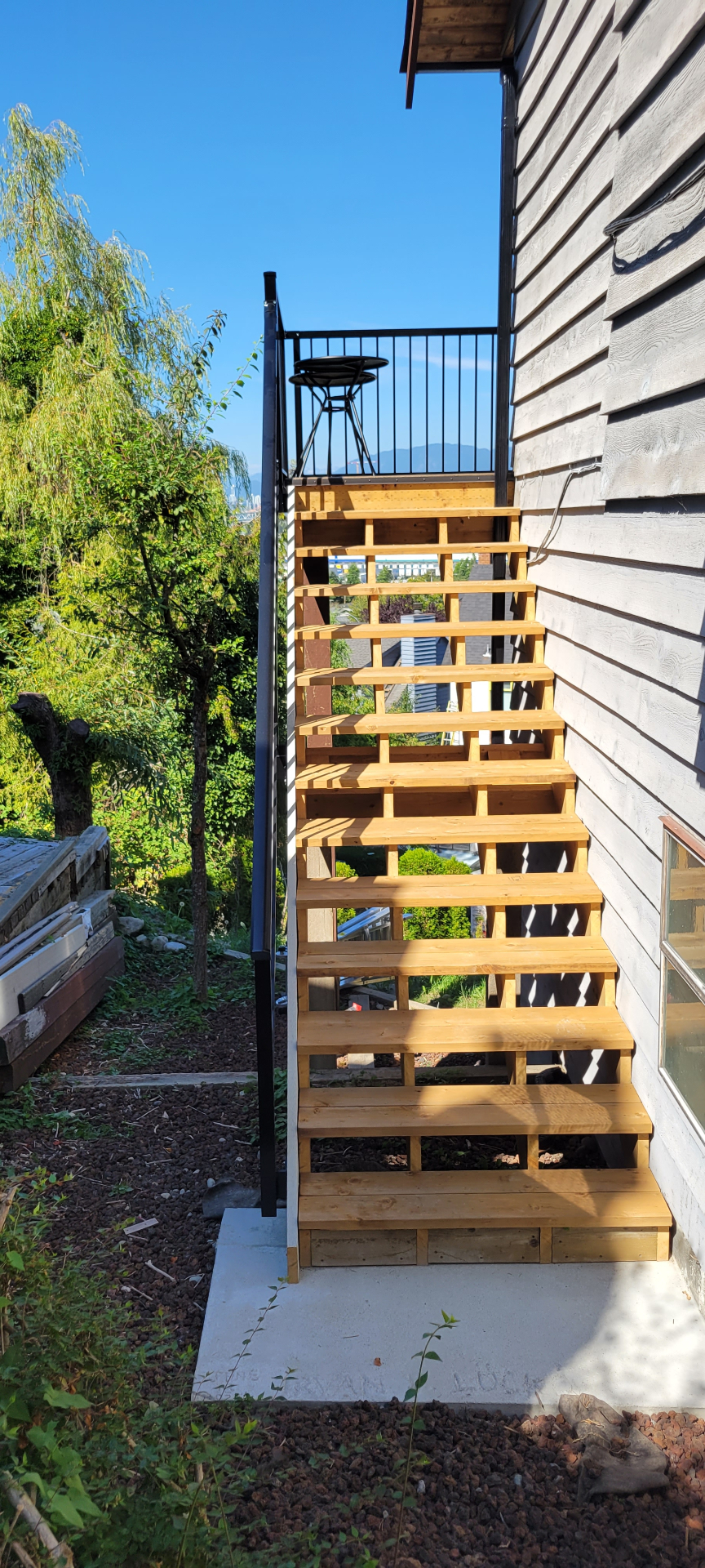 New cedar stair stringers and treads with black railing