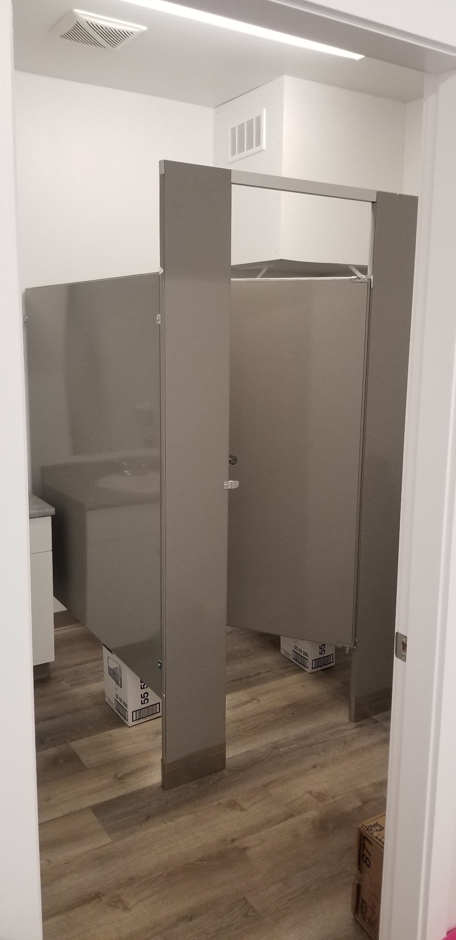 New bathroom addition with privacy partitions and vanity