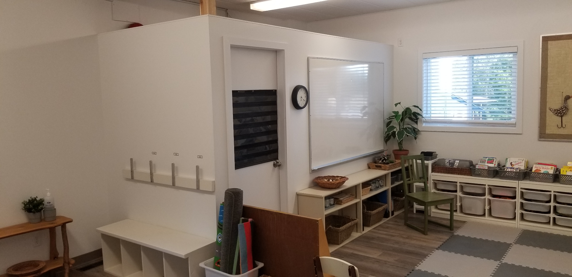 Renovated classroom interior with whiteboard, storage, and reading area