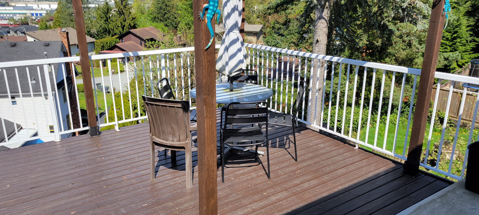 Original wood deck with white railing before rebuild