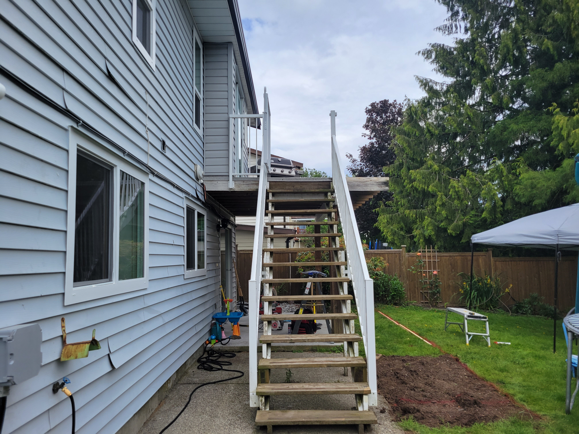 Original wooden stairs and railing before rebuild
