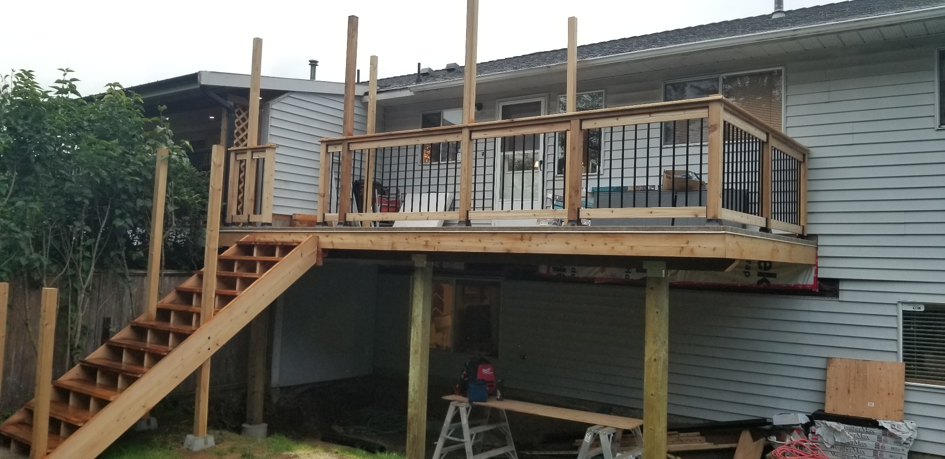 Cedar deck structure and railing under construction